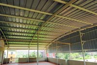 Roof-Arch shaped<br/>Truss- round-4 inch single with vertical support pillars<br/>Sheet-Autumn red Gal aluminium Industrial Corrugation Sheet<br/>Gutter- Boxed Gal aluminium Plain sheet